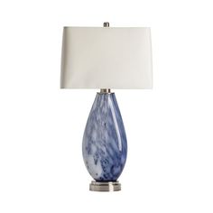 a blue and white table lamp with a square shade on it's base, against a white background