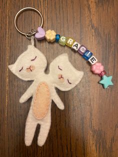 a stuffed animal keychain with a name tag attached to it