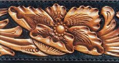 a leather wallet with gold flowers on it