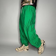 "Vintage Track Pants Kelly Green Nylon Joggers Elastic Cuffs has Ankle Zippers 90s Skate / Streetwear Great Condition: 9/10 Men's Size: 2X-Large My Hands in Pockets = It has Pockets No Hands in Pockets = Does Not Have Pockets Drawstring Will be Visible in Forward Pic, if not Visible it Does Not Have a Drawstring About me: I am 6' 0\" for reference I generally wear a Large (32\" inseam) I Model XS to 2XL sweatpants, I find that you can often size up or down with 95% of sweatpants and they fit the same" Green Parachute Pants With Elastic Waistband For Streetwear, Green 90s Style Streetwear Bottoms, Green Stretch Parachute Pants For Outdoor, Green Nylon Parachute Pants For Streetwear, Green Parachute Pants For Streetwear, Green Nylon Sporty Parachute Pants, Casual Green Nylon Parachute Pants, 90s Baggy Parachute Pants, 90s Style Baggy Parachute Pants