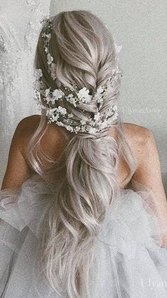 a woman with long hair wearing a wedding dress and a flower crown on her head