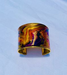 Abstract hand painted gold plated brass cuff bracelet. Measures 2"x6". Adjustable. Purple, gold, copper and blue. Artistic Copper Cuff Bangle Bracelet, Patina Brass Bangle Bracelet, Unique Gold-colored Copper Bangle, Gold Copper Cuff Bracelet With Patina, Vintage Brass Cuff Bracelet With Patina, Brass Cuff Bracelet, Brass Cuff, Gold Bracelet Cuff, Gold Cuffs