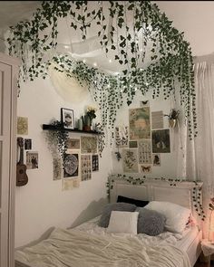 a bedroom with lots of plants hanging from the ceiling