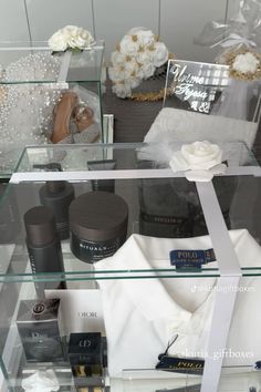 a display case filled with lots of different types of cosmetics and personal care items on top of glass shelves