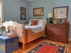 a bedroom with a bed, dresser and rug on the floor in front of a window