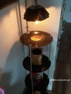 a lamp that is sitting on top of a shelf next to a table with a record