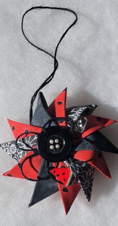 a black and red pinwheel with buttons on it