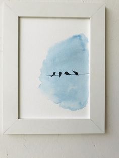 watercolor painting of birds sitting on a wire with blue sky in the back ground