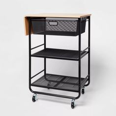 a black cart with two baskets on top of it and one drawer under the cart