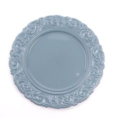 a blue plate with ornate designs on the rim is shown in front of a white background