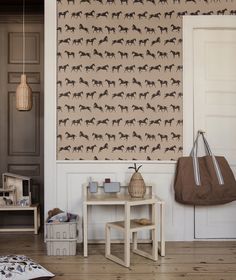 a living room filled with furniture and walls covered in horse wallpaper, along with a rug