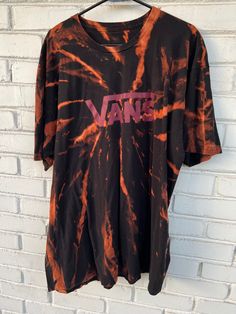 Step up your streetwear game with this unique and stylish Vans Reverse Tie Dye Shirt. Made from a high-quality upcycled tee, this shirt features a striking black and red reverse tie dye design that's perfect for skateboarders and streetwear enthusiasts. This shirt is perfect for anyone who wants to show off their individual style and love for streetwear fashion. The Vans logo on the front adds an extra touch of cool to this already stylish shirt. It's unisex design makes it a versatile piece that can be worn by anyone, and the upcycled tee material ensures that it's environmentally friendly and sustainable. sak The reverse tie dye design of this Vans shirt is eye-catching and unique, making it the perfect statement piece for any outfit. The shirt is comfortable and lightweight, making it p Tie Dye Graffiti Print Crew Neck Top, Tie Dye Crew Neck Top With Graffiti Print, Casual Tie Dye T-shirt With Graffiti Print, Casual Tie-dye T-shirt With Graffiti Print, Tie Dye Graphic Print Top For Streetwear, Tie Dye Tops With Graphic Print For Streetwear, Tie Dye Screen Print Tops For Streetwear, Casual Tops With Graffiti Print For Skateboarding, Tie Dye Crew Neck Top For Streetwear