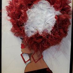 a woman's head is adorned with red and white feathers