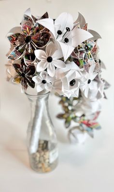 a vase filled with paper flowers on top of a table