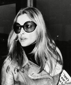 black and white photograph of a woman wearing sunglasses