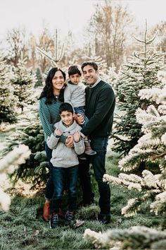 a family standing in front of a christmas tree