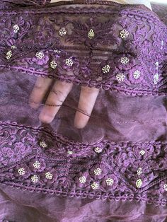 This is a semi-sheer, soft, and fluffy plum organza fabric.  It has plum (tone to tone) embroidered floral motifs all over the fabric in parallel rows. Each parallel row of embroidered motifs is about 3 inches wide. The intricate embroidery has been done in soft silk threads. The embroidery has been further embellished with muted gold sequins. The sequins are sewn in the shape of small flowers. Sequins are sewn (not pasted), so will not fall off with use. All four edges are hemmed with silk thre Embroidered Motifs, Organza Fabric, Intricate Embroidery, Fabric Remnants, Gold Sequins, Semi Transparent, Floral Motifs, Silk Thread, Bridal Veil