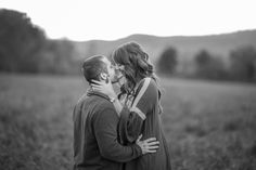 a man and woman kissing in a field