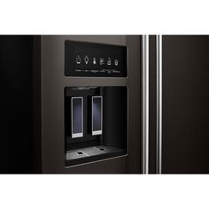 a black refrigerator with the door open and water dispenser on it's side