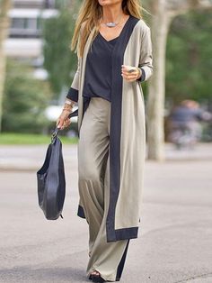 This incredibly versatile outfit features a sleeveless camisole top, a long-sleeved cardigan jacket, and a pair of loose-fitting trousers. For women who appreciate a style featuring a contrast of colors, this is a great outfit that can be worn out and about or as at-home loungewear. They're also favorites as sleepwear. The luxury feel of the polyester fabric makes this three-piece ensemble ultra comfortable. At the same time, it's also durable and works with your body, thanks to the slight spand 3 Piece Suit Women, Pant Suits For Women, Womens Office, Gilet Long, Pantsuits For Women, Estilo Chic, Casual Cardigans, Three Piece Suit, Cardigan Long