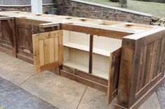 an outdoor kitchen made out of old wooden doors and drawers is shown in the process of being built