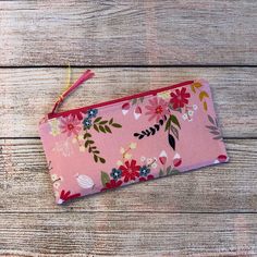 Zipper Pouch featuring a pretty floral pattern on a pink background fabric. Many uses for this stylish Reusable Zipper Pouch. Use as a Cosmetic Bag, Pen & Pencil Stationery Bag, USB cords, Makeup, Sunglass Case, Cash & ID, Cellular phone or anything else imaginable that you want to keep organized and together or protected.  4"H x 8.25" W Outer is 100% Cotton Fabric interfaced for thicker and stronger wear  Fully lined with 100% cotton fabric Zipper sewn with Zipper tabs to make bag nice and squa Make Bag, Pouch Bags, Purse Organizer, Cellular Phone, Background Fabric, Purse Organization, Gift For Her Birthday, Pen Pencil, Zipper Bag