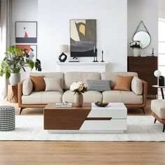 a living room filled with lots of furniture and decor on top of a hard wood floor