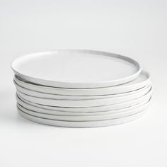 six white plates stacked on top of each other