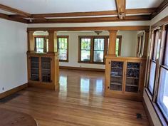 an empty living room with wood floors and windows