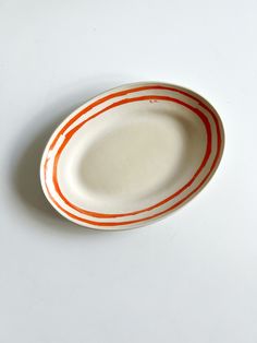 an orange and white plate sitting on top of a table