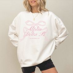 tied together with a bow <3 ♡ Super soft sweatshirt comes in unisex sizing! Reference the size chart for additional details. It is recommended to SIZE UP for an oversized fit   ♡ Sweatshirt comes in white with a light pink print. Please check listing photos for color reference! ♡ Please make sure you are ordering for the correct sorority before placing an order! This listing is for ALPHA DELTA PI. We are unable to accept returns or exchanges for this since all items are made to order.   ♡ INSTRUCTIONS FOR CARE:  1. Turn inside out before washing  2. Wash on a gentle cycle  3. Recommended not heat dry to prevent any minimal shrinking, hang to dry instead ♡ It is important that you LOVE your product! If you have any questions or concerns upon receiving your product, please contact me immedia Cotton Sorority Sweatshirt With Graphic Print, Cotton Sweatshirt With Graphic Print For Sorority, Sorority Long-sleeve Cotton Sweatshirt, Sorority Long Sleeve Graphic Sweatshirt, Sorority Graphic Print Long Sleeve Sweatshirt, Sorority Sweatshirt With Letter Print In Relaxed Fit, Cotton Sorority Sweatshirt With Long Sleeves, Cotton Long Sleeve Sorority Sweatshirt, Spring Sorority Long Sleeve Sweatshirt