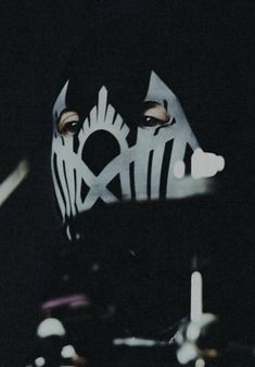 a person wearing a black mask with white lines on it