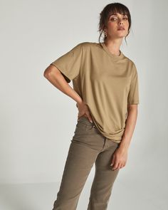 A 4-way stretch lightweight cotton tee that fits oversized. Perfect with biker shorts or tucked in with your favorite pair of joggers or jeans. Details Model is 5'10" and wears a size small. Care: Turn inside out. Machine wash cold on delicate cycle with similar colors. Tumble dry on low. Iron on low if needed. Composition: 57% Cotton | 38% Modal | 5% Spandex | 7DIAMONDS Women's Boyfriend T-Shirt in Khaki | Size Small Khaki Relaxed Fit Tops For Everyday, Versatile Oversized T-shirt, Versatile Oversized T-shirt For Everyday, Tan Relaxed Fit Crew Neck T-shirt, Khaki Crew Neck T-shirt With Pockets, Oversized Khaki Cotton T-shirt, Boxy Fit Organic Cotton T-shirt With Crew Neck, Beige Relaxed Fit Organic Cotton T-shirt, Everyday Tote