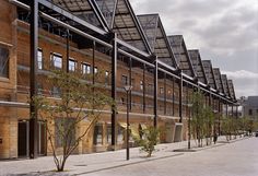 the building has many windows on it's sides and is made out of wood