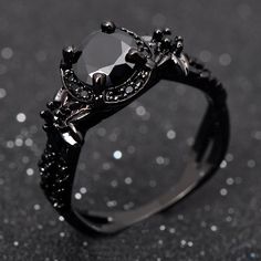 a black diamond ring sitting on top of a table