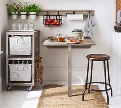 a kitchen with a table and stools in it