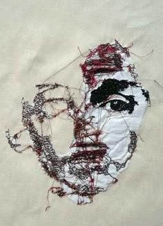 a piece of cloth with a drawing of a man's face and hair on it