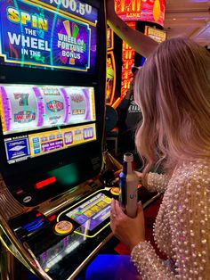 a woman playing slot machines in a casino