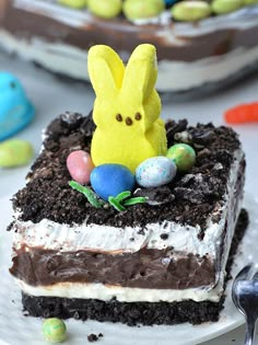 a piece of cake with chocolate frosting and peep ears on top