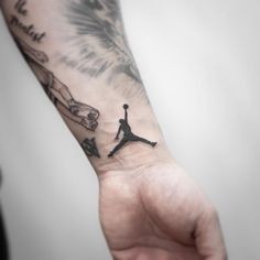 a person's arm with a tattoo on it and a basketball player holding the ball