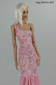 a barbie doll wearing a pink dress with flowers on it's skirt and headpiece