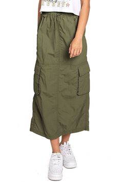 Chic, parachute skirt with an elastic waistband, a drawstring cinch tie and cargo pockets down the sides. Pair it with a graphic tee and sneakers for an effortless streetwear look. CARE | Machine Wash Cold CONTENTS | 100% Nylon MEASUREMENTS | 33"/85 cm Top to Bottom (Size Small) MODEL | 5'8 - wearing a size Small IMPORTED Casual Cargo Skirt With Drawstring For Summer, Casual Drawstring Cargo Skirt For Summer, Casual Summer Cargo Skirt With Drawstring, Casual Summer Cargo Skirt, Spring Nylon Cargo Skirt With Pockets, Casual Khaki Cargo Skirt With Pockets, Casual Khaki Cargo Skirt For Spring, Casual Cotton Cargo Skirt With Elastic Waistband, Casual Green Cotton Cargo Skirt