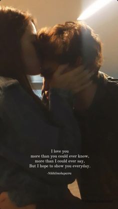 two people kissing each other in front of a window with the words i love you more than