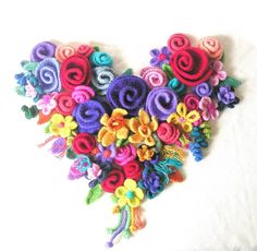 there is a heart made out of crochet yarns and flowers with the words crochet pattern on it