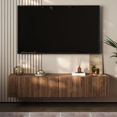 a flat screen tv mounted to the side of a wooden cabinet in a living room