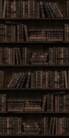 a book shelf filled with lots of books on top of wooden shelves next to each other