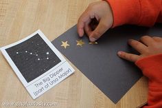 a young child is making a star shaped card with the word, the big dipper