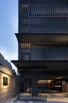 the entrance to an apartment building is lit up at night