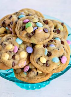 chocolate chip cookies with m & m candies in the middle on a blue plate