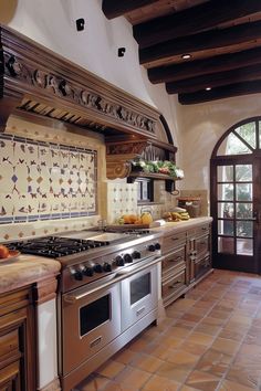 a kitchen with an oven, stove and counter top in the middle of the room